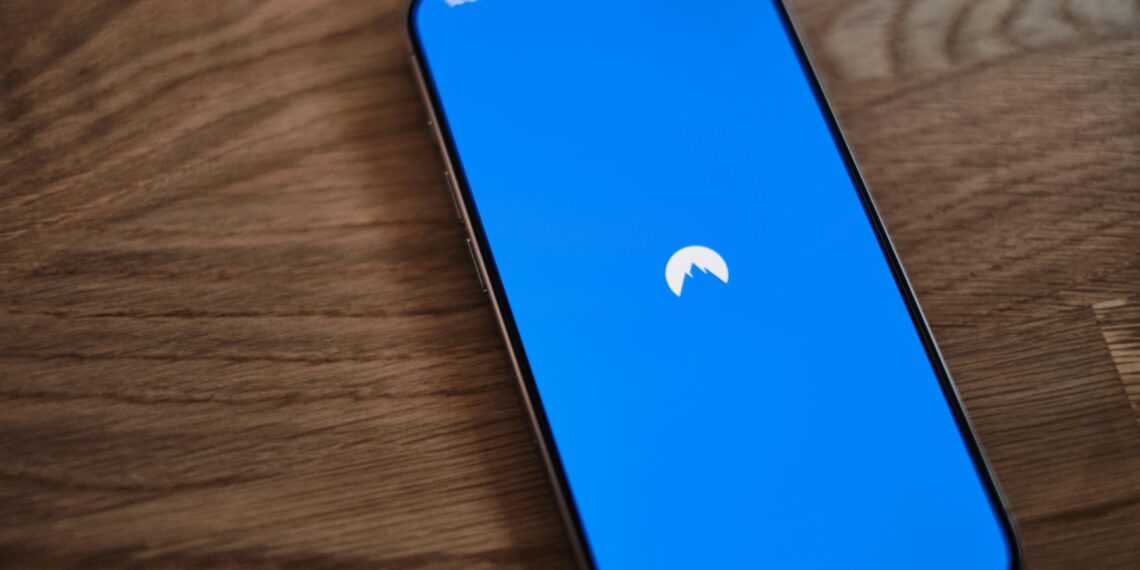 A blue phone sitting on top of a wooden table