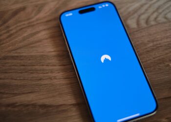 A blue phone sitting on top of a wooden table