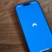 A blue phone sitting on top of a wooden table
