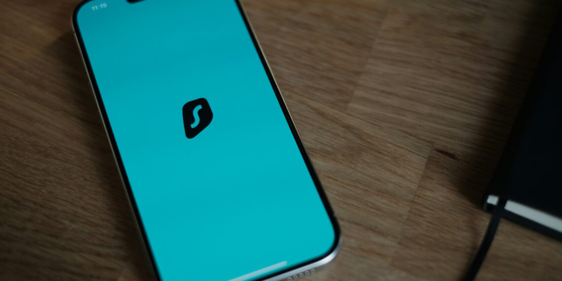 A cell phone sitting on top of a wooden table