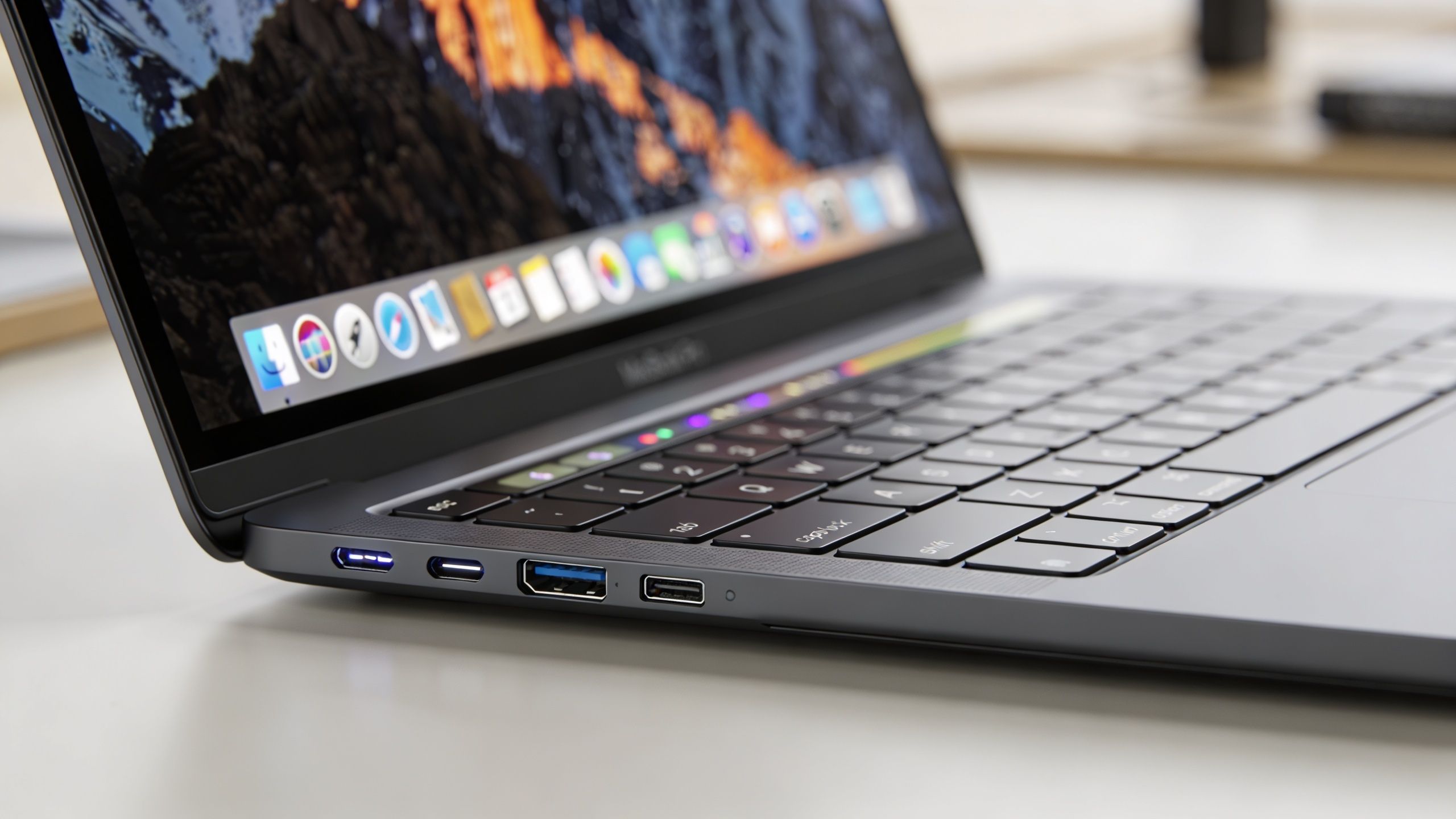A close-up view of a modern laptop showing multiple USB and Thunderbolt ports on its side.